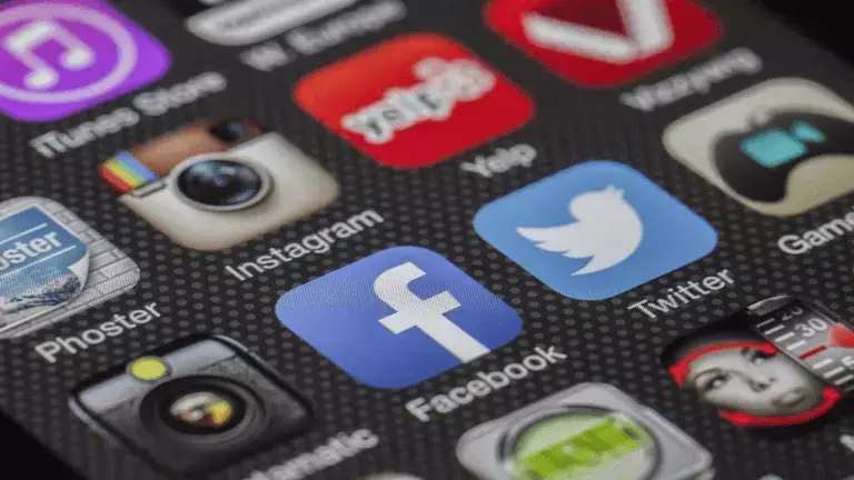 Ideal customer article link and header image - Social media platform app logos pictured on a close zoom of a mobile phone screen.